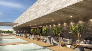 an outdoor swimming pool with chairs and a building at Gav resort beach in Salinópolis +1 photo