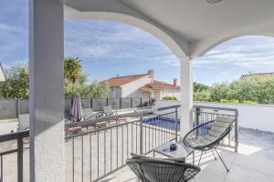 a balcony with chairs and a view of a pool at Little Paradise in Nova Vas