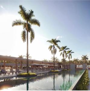 a resort with palm trees and a swimming pool at Gav resort beach in Salinópolis