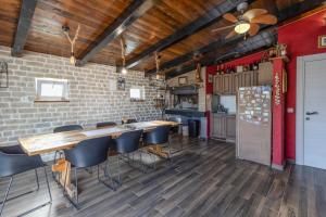 a room with a table and chairs and a kitchen at Little Paradise in Nova Vas