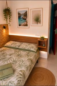 a bedroom with a bed and a nightstand and a bed sidx sidx sidx sidx at Pensión Jordi Tossa de Mar in Tossa de Mar +2 photos
