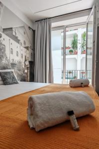 a bedroom with a bed with a towel on it at NILO RELAIS a san domenico maggiore in Naples