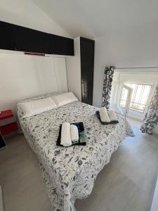 a bedroom with a bed with two pillows on it at Casa Cal y Sol in Olvera +34 photos