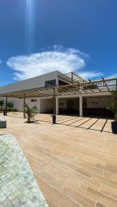 a large white building with a large patio at Casas Carole Maramar Beach House 35 e 36 in Luis Correia