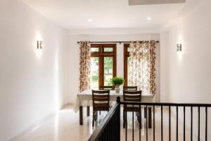 a dining room with a table and chairs and a window at Nine Gems villa in Kandy