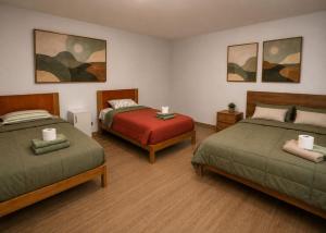 a room with two beds and a table in it at MyAbancayHome in Abancay +2 photos