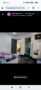 a screenshot of a picture of a bedroom with a bed at Hotel green chinar & restaurant in Srinagar