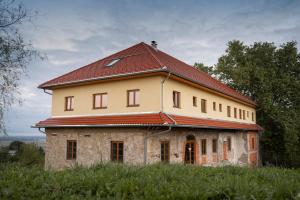 an old house with a red roof on a field at Villa Kasimir in Videm pri Ptuju