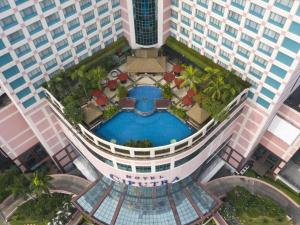 an overhead view of a building with a swimming pool at Hotel Ciputra Jakarta in Jakarta