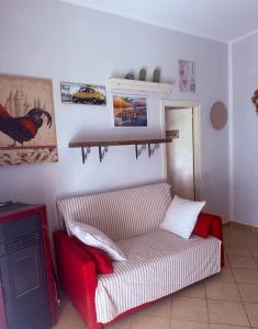 a living room with a couch and a shelf on the wall at Appartamento elba da Susanna in Portoferraio
