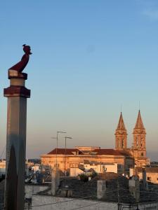 a view of a building with a church in the background at Dimora Violetta in Alberobello
