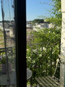 a view from a window of a balcony with a bench at Dimora Violetta in Alberobello