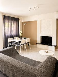 a living room with a couch and a table at polyxeni house in Lygia +11 photos