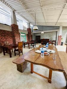 a large room with wooden tables and benches in it at Airport Heritege in Negombo