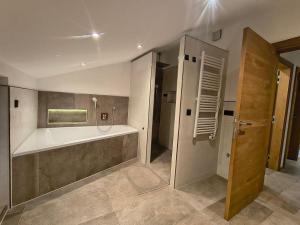 a large bathroom with a tub and a shower at biohof Stiedler in Sankt Johann in Tirol +42 photos