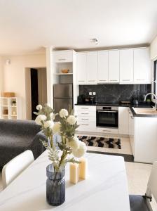 a kitchen with a table with a vase of flowers on it at polyxeni house in Lygia