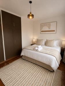 a bedroom with a bed with a towel on it at The Oak in Strand