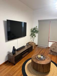 a living room with a large flat screen tv at The Oak in Strand