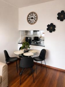 a living room with a table and chairs and a kitchen at The Oak in Strand