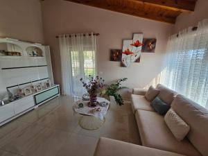 a living room with a couch and a table at Villa Theodora in Himare