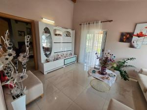 a large living room with a mirror and a table at Villa Theodora in Himare