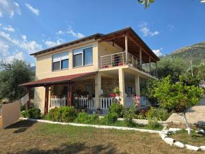 a house with a porch and a balcony at Villa Theodora in Himare