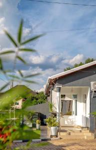 a house with a porch with chairs and plants at PENTHOUSE MPINGA RIMWEe in Kigali