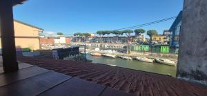 a view of a river with boats in the water at EremAre Viareggio Casa Vacanza in Viareggio