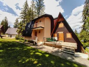 a house with a black roof at Vikendica Luna in Gornja Šišava