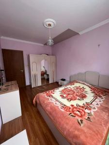 a bedroom with a large bed with flowers on it at Nakra Tower GuestHouse in Mestia