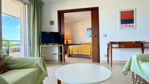 a living room with a couch and a bed and a tv at MEDES PARK II 4-3 in L'Estartit