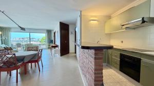 a kitchen and dining room with a table and a counter at MEDES PARK II 4-3 in L'Estartit