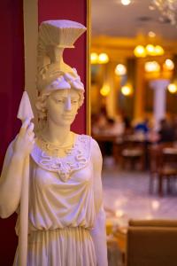 a statue of a bust of a woman holding a knife at Hotel Kosta Famissi in Kalabaka