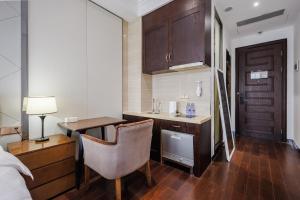 a room with a desk and a bed and a room at SEEU Designer Apartment - Qiaoxiang Metro, Futian Shenzhen in Shenzhen