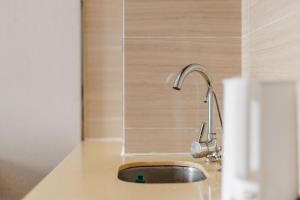 a kitchen sink with a faucet on a counter at SEEU Designer Apartment - Qiaoxiang Metro, Futian Shenzhen in Shenzhen