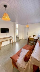 a living room with a bed and a table at Casas Carole Maramar Beach House 35 e 36 in Luis Correia