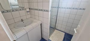 a small bathroom with a sink and a shower at Hôtel restaurant ANGEL'S in Angles +28 photos