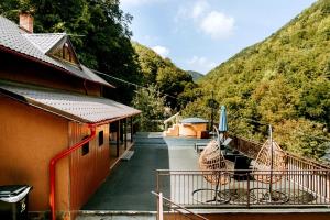 a porch of a building with a view of a mountain at Iezer Mountain Escape in Lunca Ampoiţei