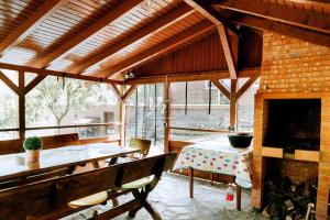a living room with a table and a fireplace at Iezer Mountain Escape in Lunca Ampoiţei