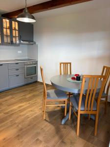 a kitchen with a table and chairs in a room at Chalet Le Klet in Krapinske Toplice