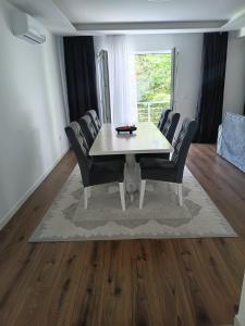 a dining room with a white table and chairs at Villa Balic Sarajevo in Sarajevo