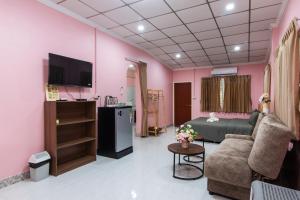 a room with a bed and a couch and a tv at PoonsukPlace Sampran in Ban Bang Yai Chuai