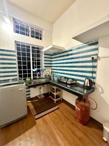 a kitchen with a counter and a sink in a room at The Gulmohar Grove in Pāsighāt