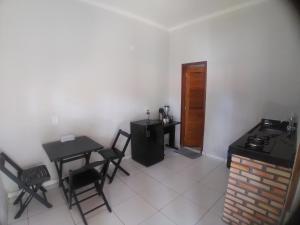 a room with two tables and a table and chairs at Yanne chalé 1 in Barra Grande