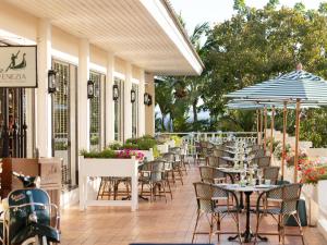 an outdoor patio with tables and chairs and umbrellas at Sofitel Krabi Phokeethra Golf and Spa Resort in Klong Muang Beach +283 photos