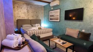 a living room with a bed and a couch at Wonderland spa free parking in Niš