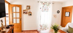 a living room with a window and a couch at La Pizpireta in Cazorla
