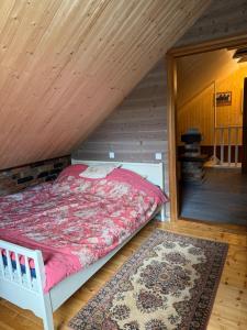 a bedroom with a bed in a attic at Loukis dvars in Luokė