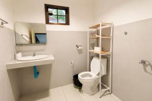a bathroom with a toilet and a sink and a mirror at Charming House - Peaceful Garden Retreat - 2mn ZenBeach - Srithanu Center in Srithanu +75 photos