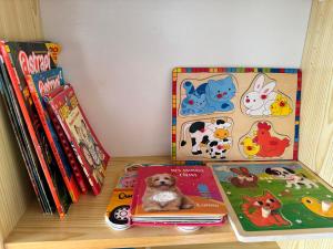a shelf with childrens books and a dog on them at Le Panorama de Valberg in Valberg